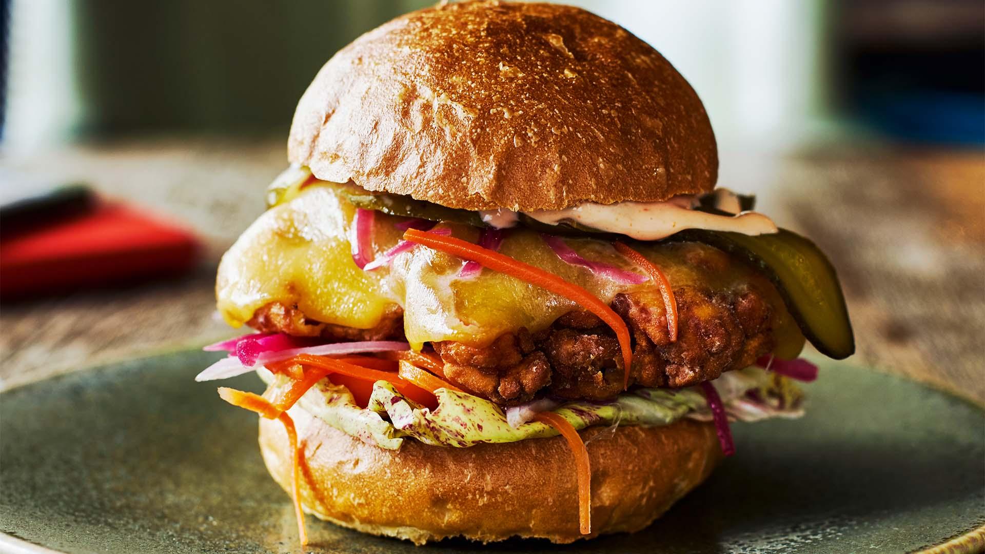 jerk chicken burger with applewood cheddar and spicy sriracha