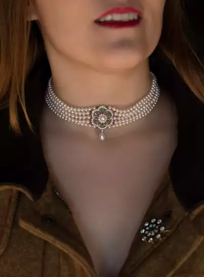 Lots 176 - A five row cultured pearl choker with diamond and emerald centrepiece estimate &pound;1,00-&pound;1,500 Lot170 - An early 20th century emerald and diamond brooch estimate &pound;800-&pound;1200