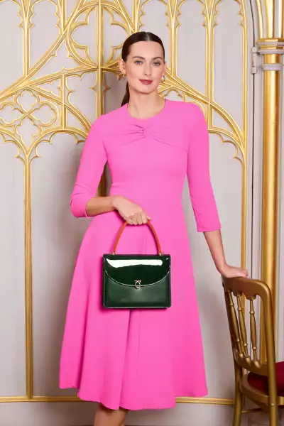 Model holding Launer Bellini handbag Model holding Launer Bellini handbag