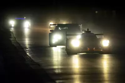 Cars driving at night at Le Mans