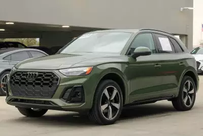 Khaki green Audi Q5 parked at a dealership in southern UK
