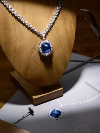 A remarkable 65.61-carat Cabochon sapphire is framed by custom-cut diamonds that mirror the same pyramid shape of the main stone