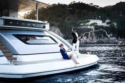 Couple spraying champagne off a boat Couple spraying champagne off a boat