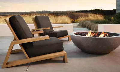 Grounds for optimism: investing in weighty, dramatic pieces, like this Olena chair from RH, anchors the garden layout.