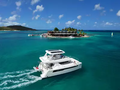 A Moorings 403PC power catamaran pulls up at Saba Rock Resort