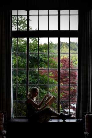 Lady sitting by a window