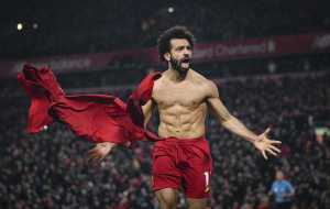 Mohamed Salah of Liverpool celebrates his goal to make it 2-0 during the Premier League match between Liverpool FC and Manchester United at Anfield on January 19, 2020 in Liverpool, United Kingdom.