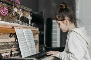 Young girl learning piano