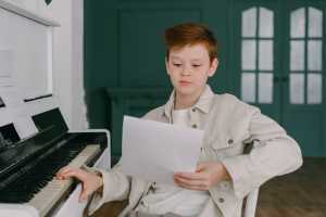 Young boy learning piano