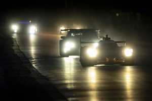 Cars driving at night at Le Mans Cars driving at night at Le Mans