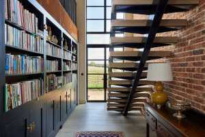 Holland Green introduced a staircase and library wall to draw the eye through to views of rolling hills beyond.