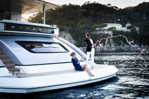 Couple spraying champagne off a boat