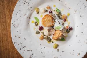 Grilled scallop with cauliflower, grape, truffle and fermented grains
