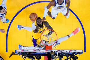 Los Angeles Lakers forward LeBron James, middle, shoots against Golden State Warriors forward Draymond Green during the first half of Game 5 of an NBA basketball second-round playoff series Wednesday, May 10, 2023, in San Francisco