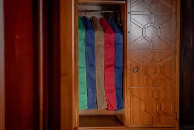 Store suits in garment bags to protect from moths