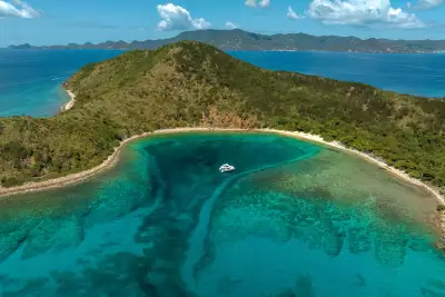 A cove with a lone moored boat in the BVI