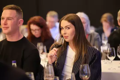 A lady tasting wine