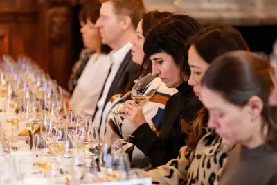 A lady tasting wine