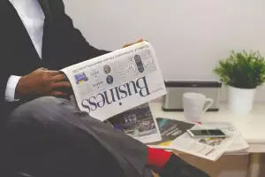 Man reading business newspaper
