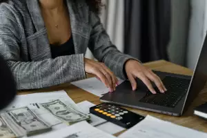 Woman at laptop county money
