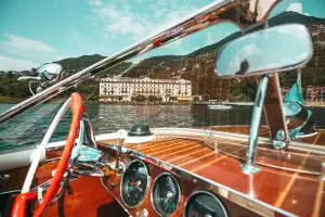Exploring Lake Como aboard a classic wooden boat — a hallmark of Luxo Italia’s bespoke journeys.