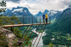 A couple overlooking an Alpine scene