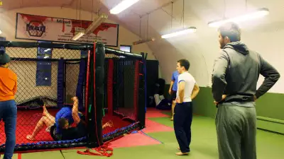 People training in MMA Cage at MMA Den Battersea London