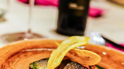 Fillet of bass with black eye bean salsa, basil dressing and plantain crisp