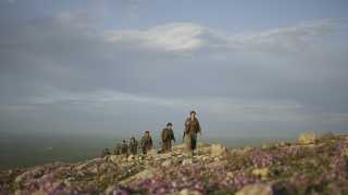 Kurdistan Workers’ Party (PKK) guerrillas on an armed patrol in the countryside of Makhmur