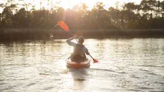 Man Kayaking in Alabama at Sunset