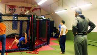 People training in MMA Cage at MMA Den Battersea London