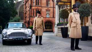 Doorman and Aston Martin DB5 outside The Connaught Hotel