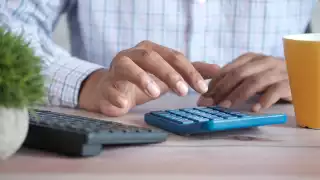 An accountant typing in his calculator