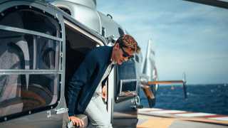 F1 driver George Russell in Monaco stepping out of a helicopter