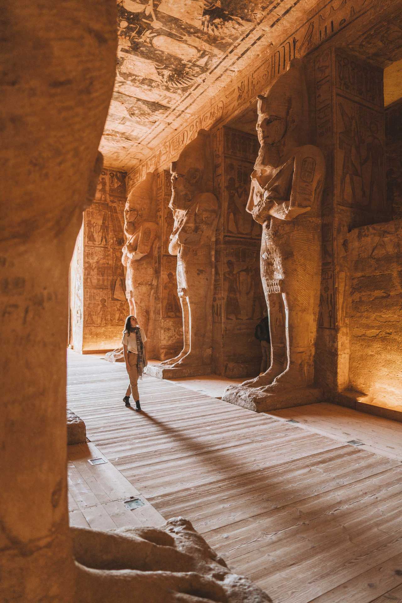 A young Caucasian woman walking inside Abu Simbel temples