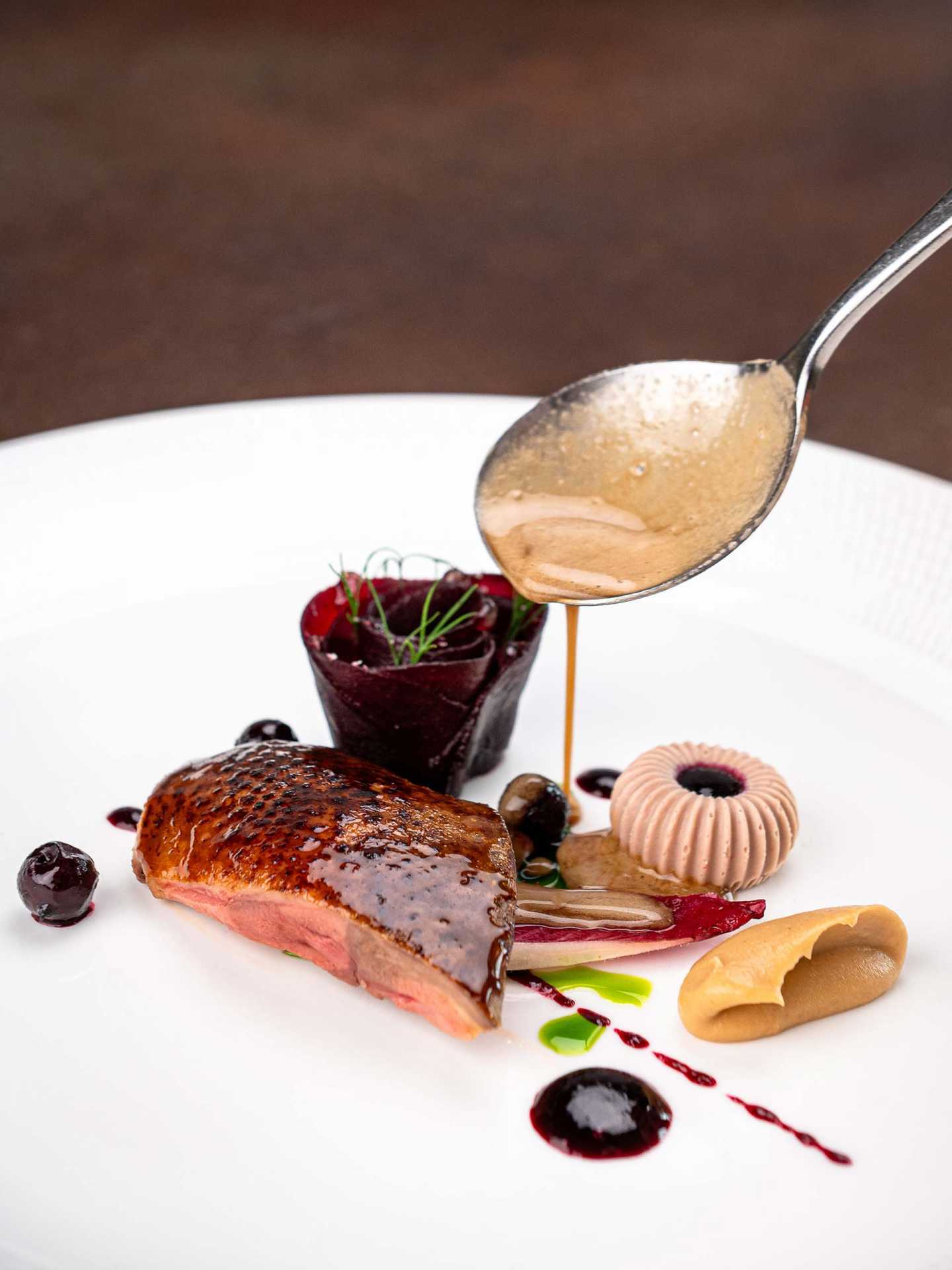 Squab pigeon with Heirloom beetroot, blackcurrant, and nasturtium