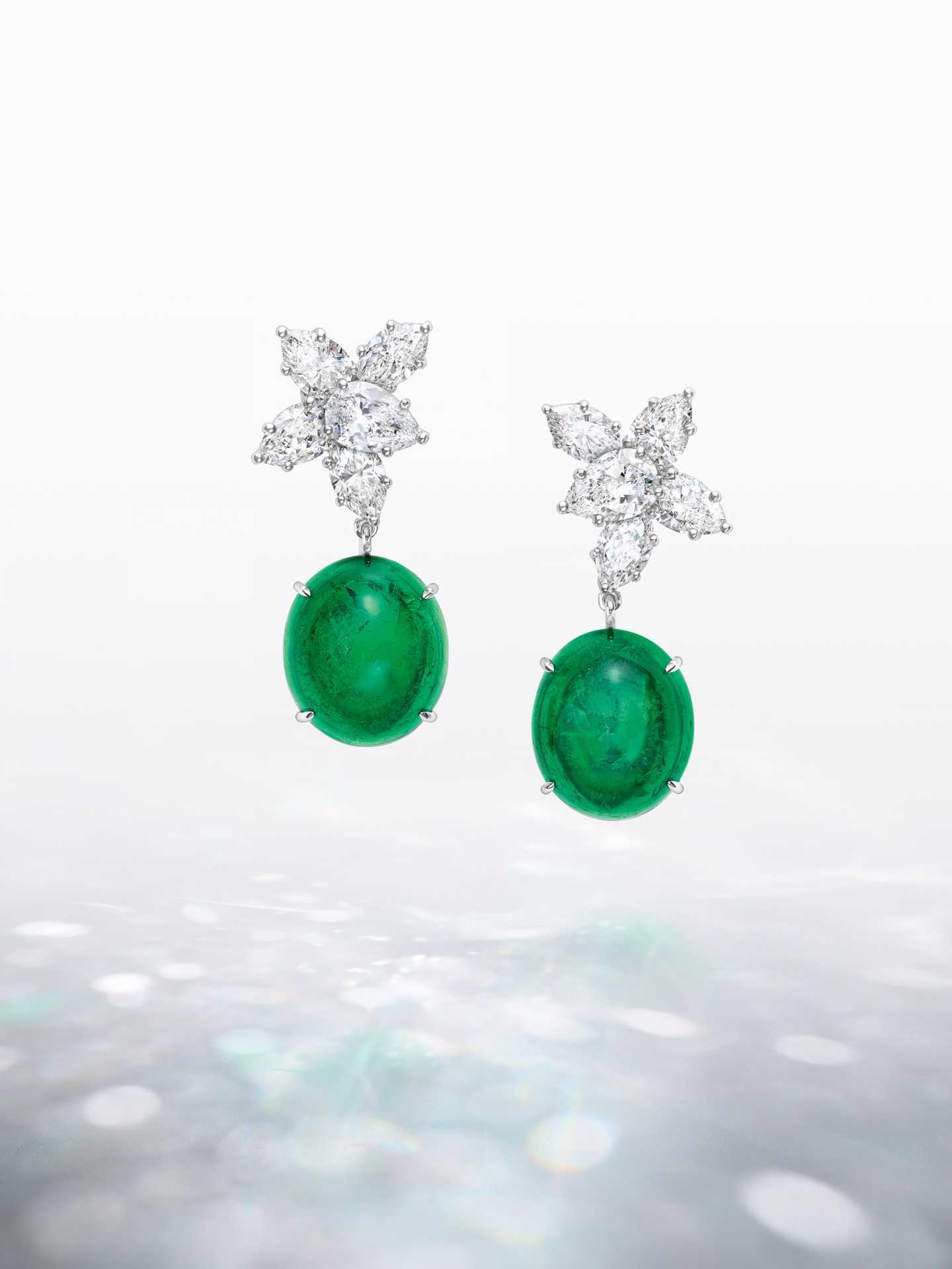 Talk to Me, Harry Winston Collection pair of Cluster diamond earrings elegantly frame two Colombian emerald cabochons, weighing 17.79 and 17.25 carats.