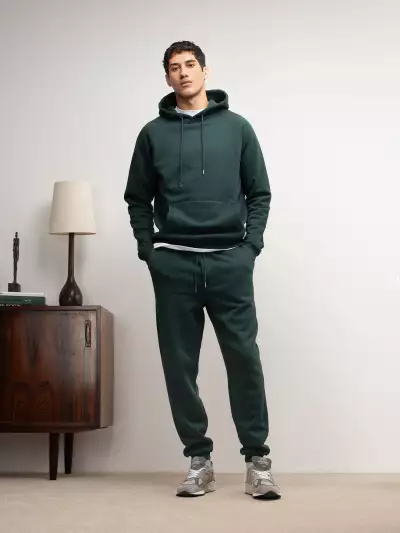 Hamilton & Hare model wears pullover hood track pant in gate green, priced &pound;165 and &pound;130 respectively.