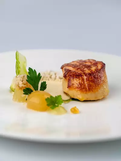 Orkney scallop with orchard apple, walnut, and gorgonzola crumble