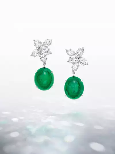 Talk to Me, Harry Winston Collection pair of Cluster diamond earrings elegantly frame two Colombian emerald cabochons, weighing 17.79 and 17.25 carats.