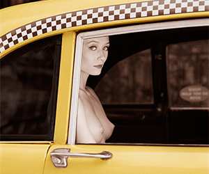 Nude woman in a checker cab