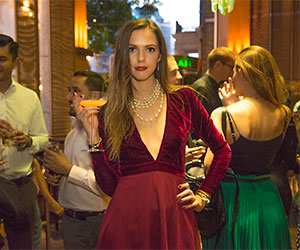 Girl in red dress holding a cocktail glass
