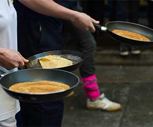 People partaking in a pancake race
