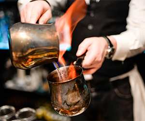 Bar tender making a flaming cocktail