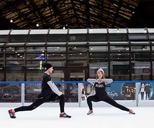 Two people doing a workout on the ice