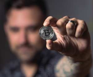 Man holding up bitcoin