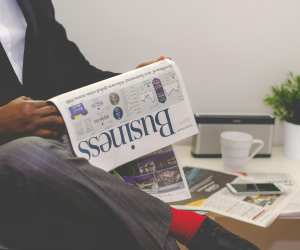 Man reading business newspaper