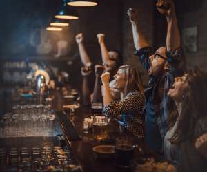 Punters enjoying sports at a bar