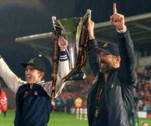 Rob McElhenney and Ryan Reynolds celebate with the National League trophy