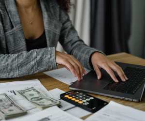 Woman at laptop county money